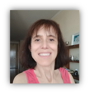 Woman with dark shoulder length hair smiles at the camera.